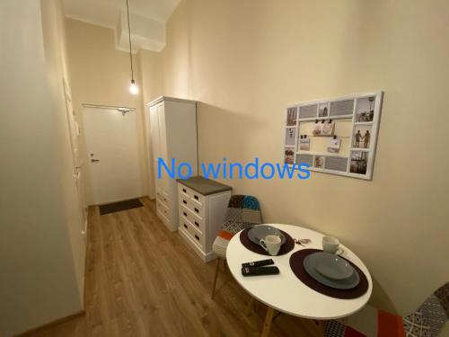 a small room with a white table and a cabinet at Kastanimaja Apartments in Tartu