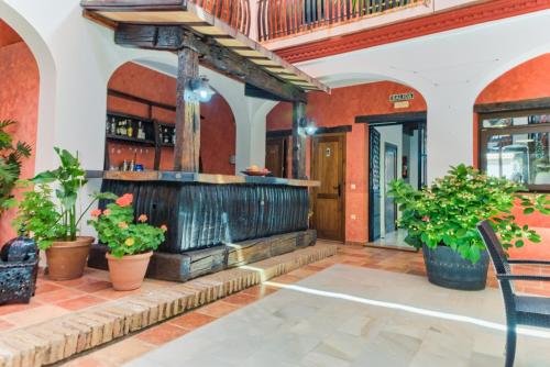 a patio with a fountain in a building with plants at Hotel Pozo Rey in Chipiona