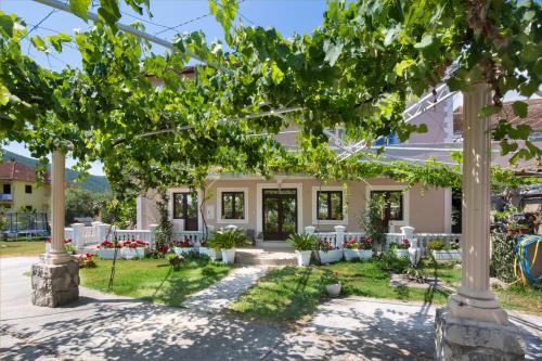 a house with a garden in front of it at Apartments Al Parma in Budva