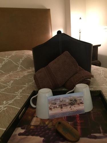 a tray of food on top of a bed at Moireas Apartments in Akrogiali