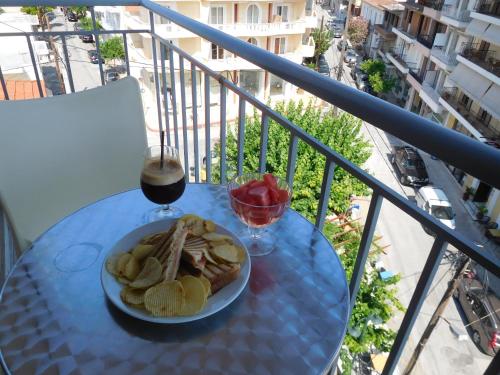 a plate of food on a table on a balcony at Efstratios Hotel in Loutra Edipsou
