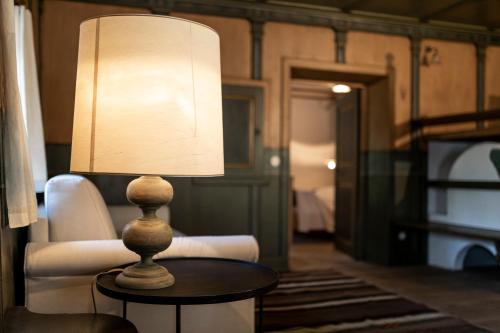 a lamp sitting on a table in a living room at Wassermann in Sesto
