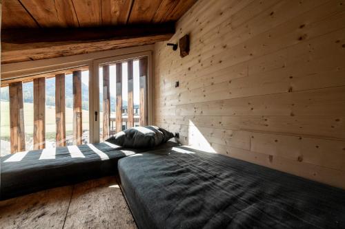 a bedroom with a bed and a large window at Wassermann in Sesto