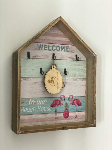 a welcome to our beach house clock on a wall at Villa Santoma Hill in Koper
