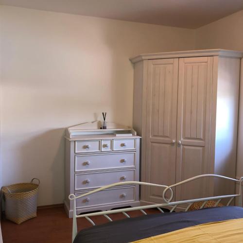 a bedroom with a white dresser and a bed at Villa Santoma Hill in Koper