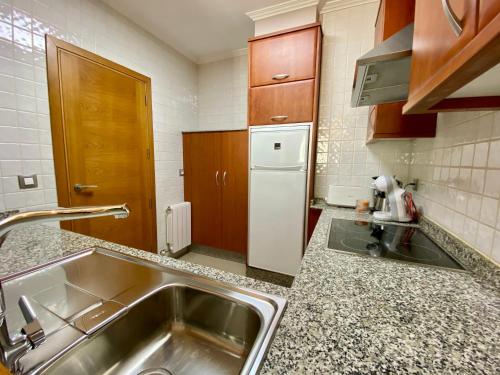 a kitchen with a sink and a refrigerator at CHURRUCA 3 in Vigo