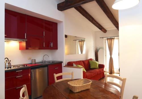 cocina y sala de estar con mesa y sofá en San Teodoro Apartment en Roma