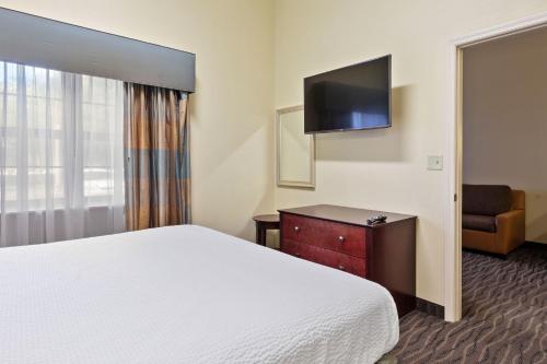 a hotel room with a bed and a television at Extended Stay America Premier Suites - Lakeland - I-4 in Lakeland