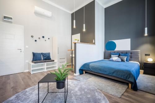 a bedroom with a blue bed and a table at K33- Quality Apartments, Best Location, by BQA in Budapest