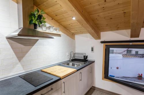 a kitchen with a sink and a counter top at Apartamentos turísticos 3 Lienzos in Peñafiel