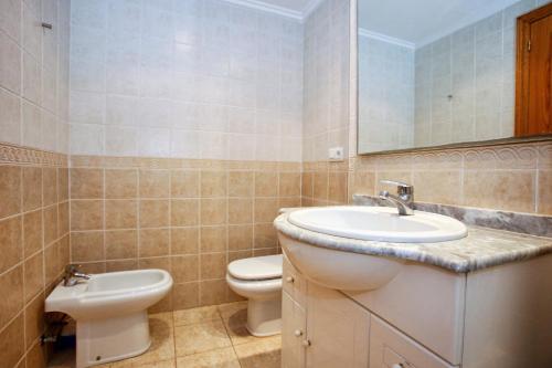 a bathroom with a sink and a toilet at Poseidon Denia in Denia