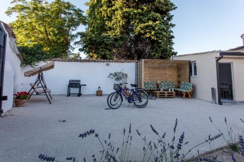 a bike parked in a parking lot next to a building at Apartamentos turísticos 3 Lienzos in Peñafiel