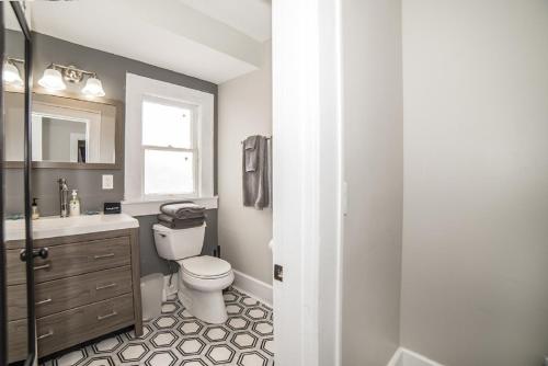 a bathroom with a toilet and a sink at St Pete Vacation Rentals in St. Petersburg