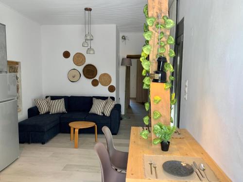 a living room with a blue couch and a table at Naiades Residence in Pigi