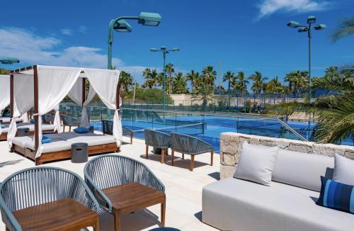 a patio with furniture and a swimming pool at Bohari Palmilla in San José del Cabo