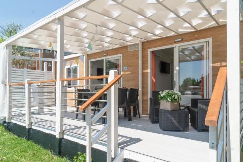 a pergola over a deck of a house at Campeggio Europa Silvella in San Felice del Benaco