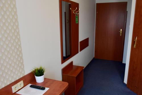 an office room with a desk and a mirror at Hotel Złote Dęby in Warsaw