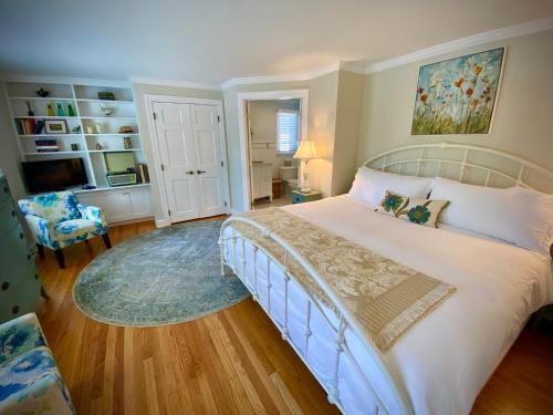 a bedroom with a large bed and a living room at The Homestead in Madison