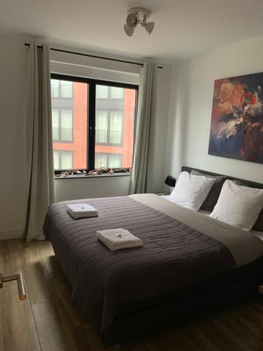 a bedroom with a large bed with two towels on it at Great B&B at Amstelbeach in Amsterdam