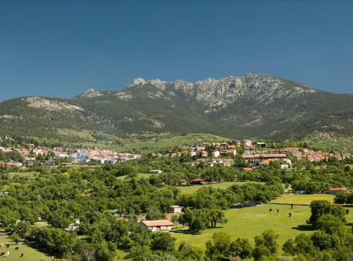 una città in una valle con montagne sullo sfondo di El Abuelo Paco a Cercedilla