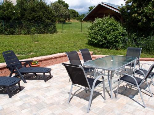 a patio with a table and chairs on a patio at Penzion Cabák in Vrchlabí