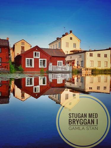 a group of buildings sitting next to a body of water at Stugan med Bryggan i Gamla Staden in Eskilstuna