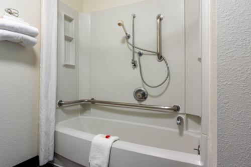 a bathroom with a bath tub with a shower at Super 8 by Wyndham Spokane Valley in Spokane Valley