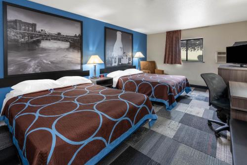 a hotel room with two beds and a tv at Super 8 by Wyndham Spokane Valley in Spokane Valley