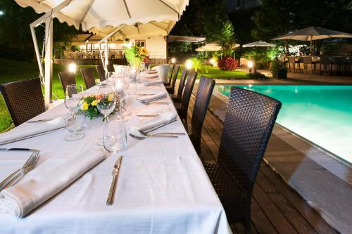 a long table with wine glasses and flowers on it at Villa Maria Cristina in Caserta