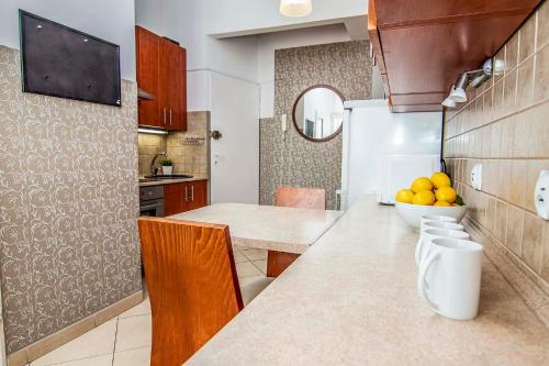 a kitchen with a counter with a bowl of oranges on it at Apartament 2 pokoje Lublin Centrum ulica Narutowicza in Lublin