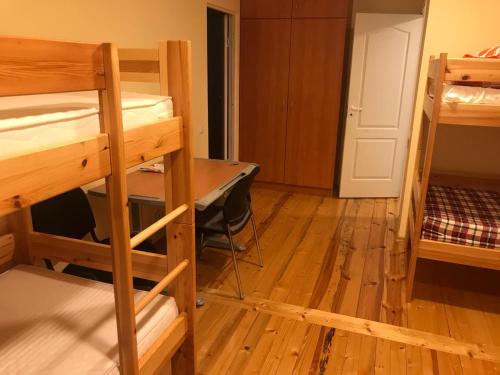 a room with bunk beds and a desk and a door at SIA Cikstonis in Rīga