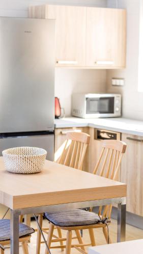 a kitchen with a wooden table and two chairs at Summer Villas Crete in Balíon