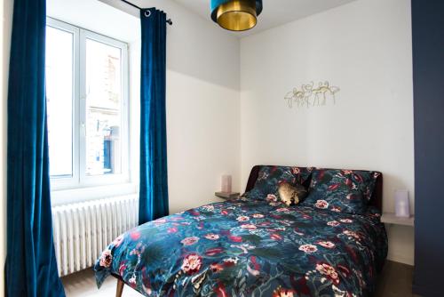 a bedroom with a bed with a dog laying on it at Théâtre Sinne Luxury Apartement in Mulhouse