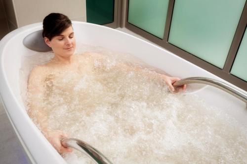 a woman is sitting in a bath tub at Venus in Karlovy Vary