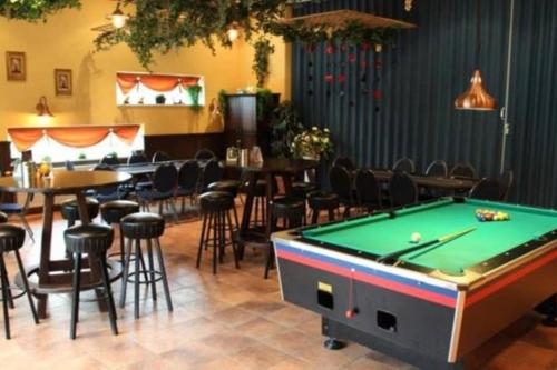 a pool table in a room with tables and chairs at Holiday-Chalet Westenwind 4p. Amsterdam & Beach in Opmeer