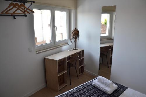 a bedroom with a desk and two windows at Portoo Blue Apartments - Amazing in Vila Nova de Gaia