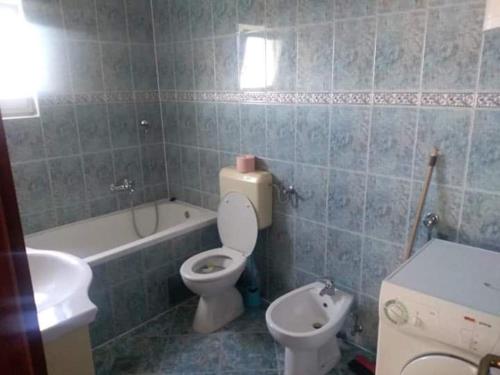 a bathroom with a toilet and a tub and a sink at Denis Bolanča in Primošten