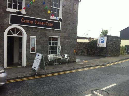 a corner street cafe with a table and chairs on the sidewalk at Room 2 Camp Street B&B & Self Catering in Oughterard