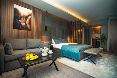 a bedroom with a bed and a couch and a table at Nova Suite Residence in Trabzon