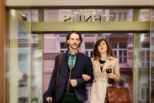 a man and a woman standing in front of a shop at Venus in Karlovy Vary