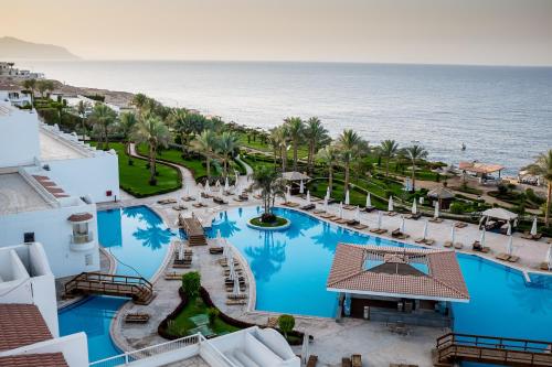 an aerial view of a resort with a pool and the ocean at Siva Sharm Resort & SPA in Sharm El Sheikh