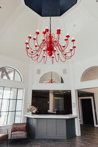 a red chandelier hanging from a ceiling in a room at Vinland Hotel and Lounge in Solvang