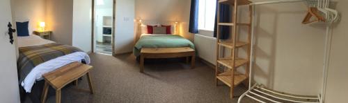 een kamer met een slaapkamer met een bed en een spiegel bij Harvest Moon-ROOMS ONLY in Doolin
