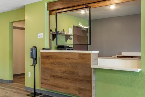 a lobby with a reception desk with a mirror at WoodSpring Suites Austin Georgetown in Georgetown
