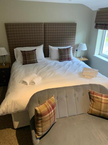 a bedroom with a large bed with two towels on it at The Dukes Head in Armathwaite