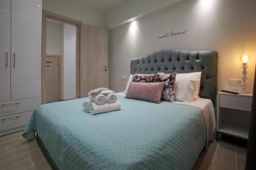 a bedroom with a large bed with a mask on it at Under the Aqueduct boutique house in Kavala