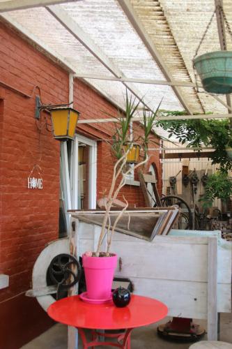 a red table with a potted plant on top of it at La clef de bois in Braine-le-Comte