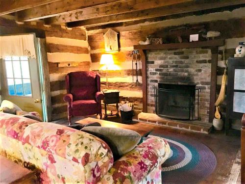 a living room with a couch and a fireplace at Heartstone Country Retreat in Buena Vista