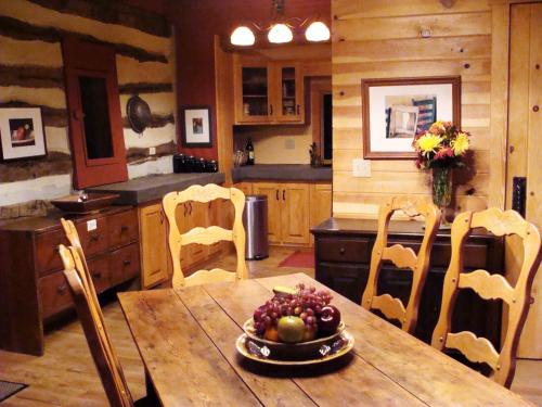 a kitchen with a table with a bowl of fruit on it at Heartstone Country Retreat in Buena Vista