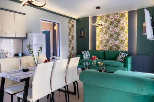 a living room with a green couch and a table at Family Inn Apartments&suites in Neos Marmaras